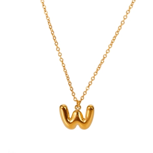 Macro detail of 18K gold-plated bubble W letter pendant on a fine O-chain necklace
