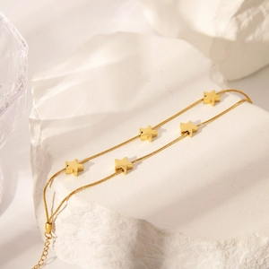 Double-layered gold-plated star pendant bracelet with sleek snake chain for women