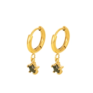 Detailed shot of golden hoop earrings featuring glossy black five-point star pendants