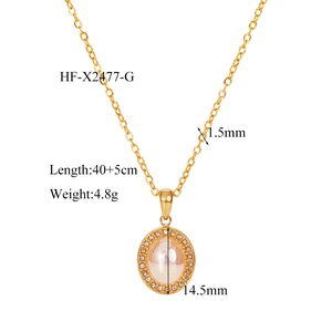 Detail of vintage gold necklace featuring a pearl pendant surrounded by small crystals