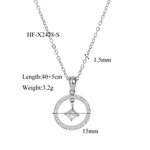 Detail of a square zircon stone inside a round pave-set pendant on a silver chain