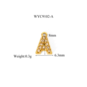 Detail view of gold letter A pendant with zircon stones showing 8mm x 6.3mm dimensions