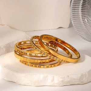 Gold plated stainless steel bracelet set with Roman numerals and zircon maple leaf