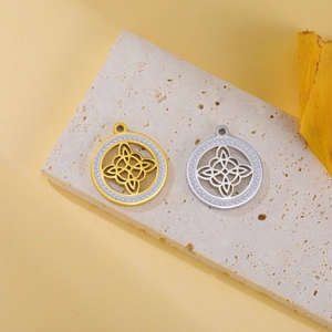 Detailed macro view of gold and silver Celtic Witch's Knot pendants with sparkling rhinestones