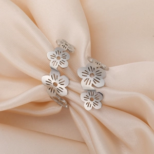 Detailed view of silver stainless steel open ring with hollow flower and bee design