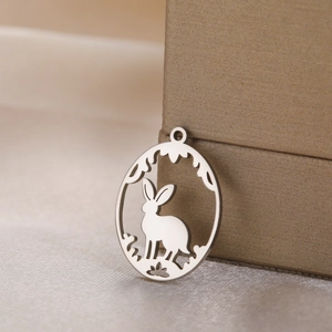 Hollow rabbit stainless steel pendant for DIY jewelry making on silk fabric background