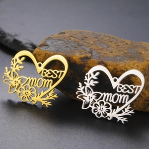 Detailed close-up of hollow heart flower pendants with BEST MOM engraving in gold and silver