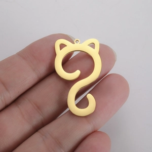 Close-up of cute cat pendant in 18K gold plated stainless steel held by hand
