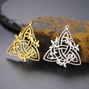 Detailed view of hollow Celtic knot pendants in gold and silver finish on stones