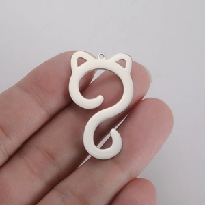 Polished silver cat-shaped stainless steel pendant charm shown held for scale