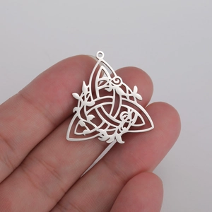 Hollow Celtic knot stainless steel pendant necklace accessory shown in hand for scale