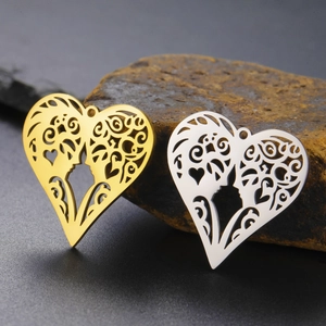 Detail of hollow heart pendants in gold and silver finish with romantic floral patterns