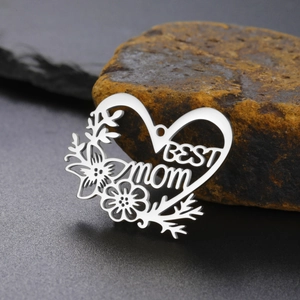 Macro shot of silver Best Mom heart pendant with floral cutouts on stone