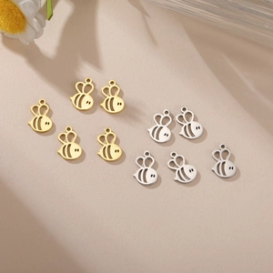 Detailed view of hollow honey bee pendants in gold and silver finishes for jewelry