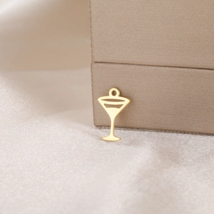Macro shot of a gold martini glass pendant with a polished finish for DIY jewelry