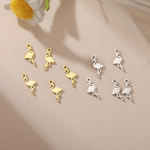 Detailed close-up of flamingo metal charms in gold and silver finish for DIY jewelry