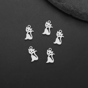 Detailed macro view of five silver cat-shaped stainless steel charms for DIY jewelry