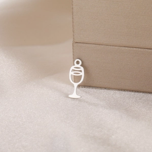 Detailed view of silver cocktail cup pendant on champagne silk for jewelry DIY