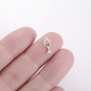 Miniature silver wine glass pendant in stainless steel held by fingers for DIY jewelry