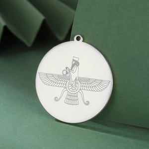 Detailed view of silver Faravahar pendant with 18K gold plating on geometric background