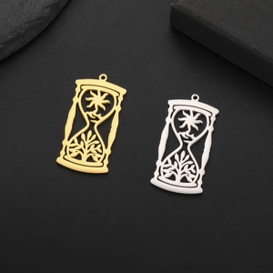 Detail of hourglass pendants in gold and silver steel with sun and leaf pattern