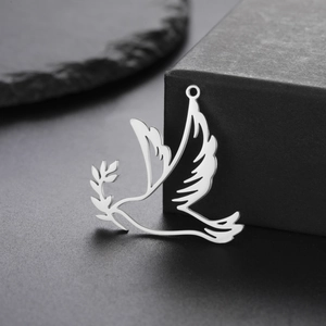 Polished titanium steel peace dove pendant with olive branch on minimalist black background