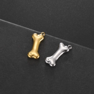Macro detail of polished stainless steel dog bone pendants in gold and silver finish