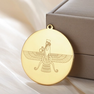 Polished 18K gold plated stainless steel Faravahar eagle round pendant on silk background