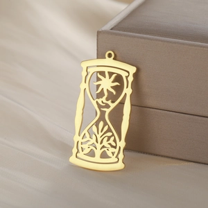 Golden sun and tree of life hourglass pendant in stainless steel displayed on satin