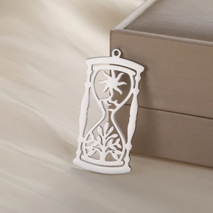 Polished hourglass pendant in titanium steel with sun and tree leaf patterns for jewelry
