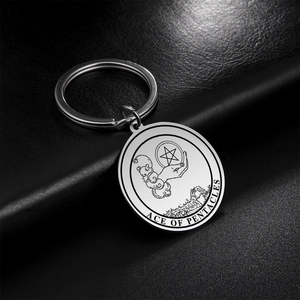Macro shot of Ace of Pentacles Tarot keychain with detailed engraving on silver metal
