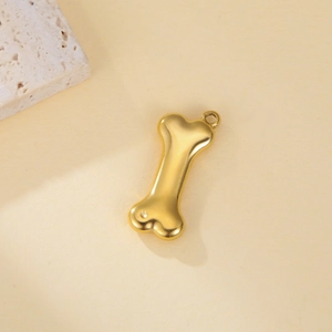 Polished gold bone-shaped stainless steel pendant with integrated ring for jewelry making