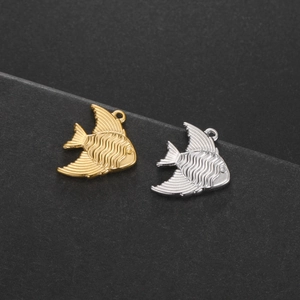 Detail of fish pendants in gold and silver finish with textured surface for DIY jewelry