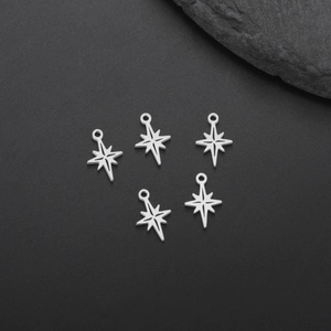 Mini stainless steel eight-pointed star charms set for DIY jewelry making on dark background