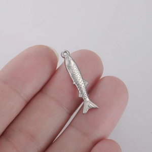 Detailed view of silver fish pendant with realistic scales and textures for jewelry making