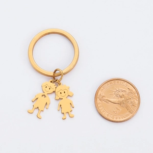 Polished gold stainless steel keychain with boy and girl pendants and size reference