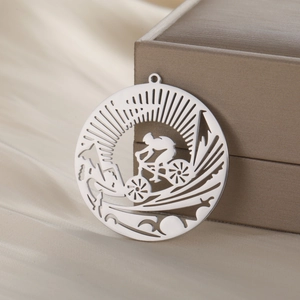 Silver hollow cycling pendant with rider and mountain scene in polished stainless steel