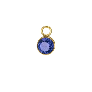 Detailed view of faceted purple birthstone pendant with polished gold metal frame