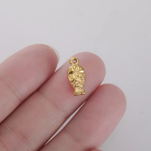 Detailed close-up of a small golden fish charm with intricate scales for DIY jewelry making