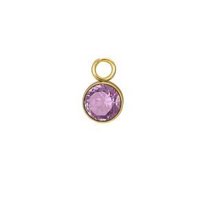 Macro shot of a purple birthstone pendant with a gold plated setting for jewelry making