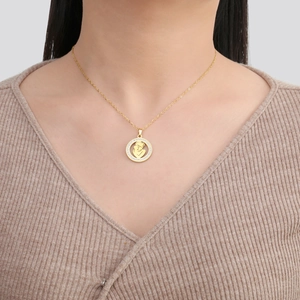Collier doré avec pendentif mère et enfant serti de cristaux sur un mannequin femme