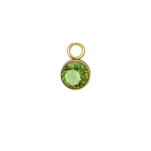 Detail of round green birthstone pendant with gold plated bezel setting and top loop