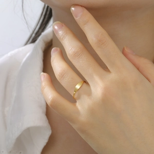 Minimalist gold stainless steel ring featuring a sleek flat geometric surface on a model
