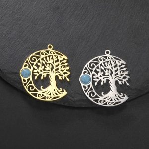 Macro detail of hollow tree of life pendants with crescent moon and turquoise inlay