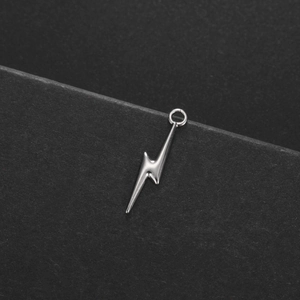 Detailed view of lightning bolt pendant in polished stainless steel with top ring