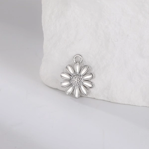Detailed close-up of a silver stainless steel daisy pendant with textured flower core
