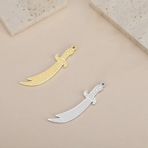 Detailed view of gold and silver scimitar sword charms for DIY necklace making