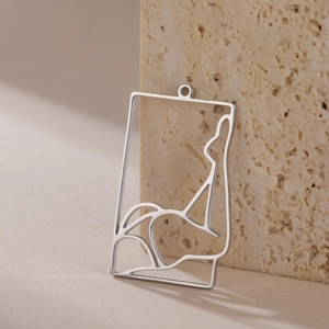 Detailed close-up of a silver rectangular hollow pendant featuring female line art