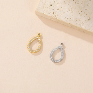Detail of gold and silver teardrop pendants with pavé crystals for jewelry making