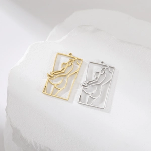 Detail of hollow rectangular pendants with abstract female silhouette in gold and silver
